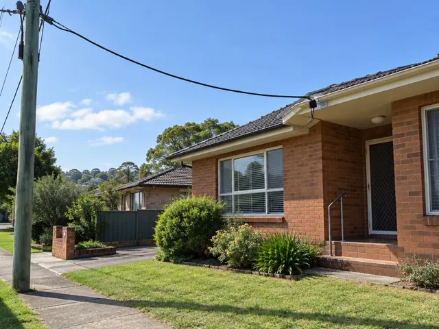 Brick house exterior with overhead service cable and eave attachment point near the roof in Baulkham Hills